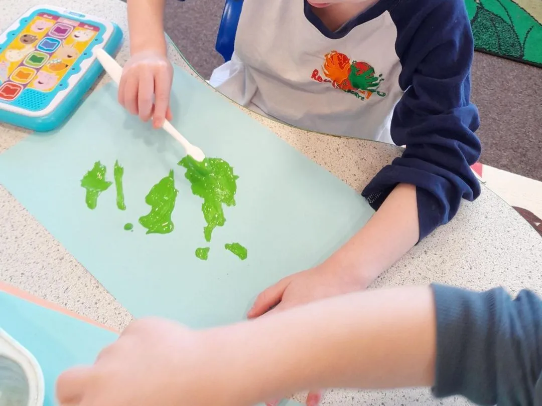 Preschool child painting at a table at Ready Steady Go Childcare Worle